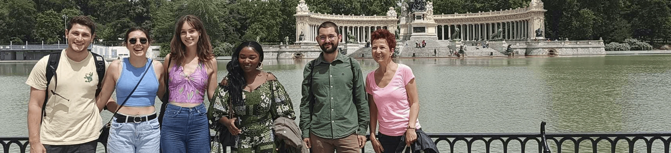 Group of international students from BLC Spain on a cultural outing at El Retiro Park in Madrid, posing in front of the Monument to Alfonso XII