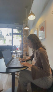 Master’s student studying on laptop at a café in Madrid