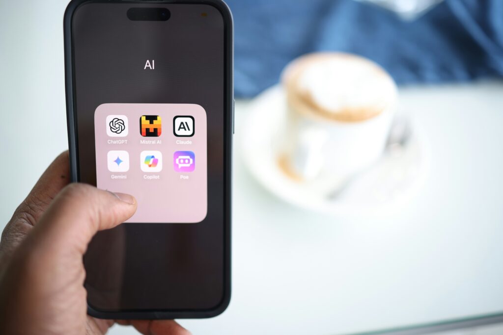 Someone holding a phone where you can see several AI apps open