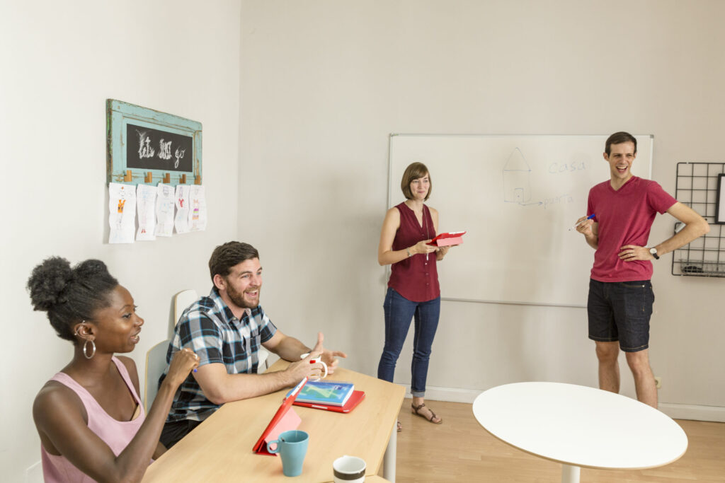 Student presenting confidently during a business master’s class in Madrid. 