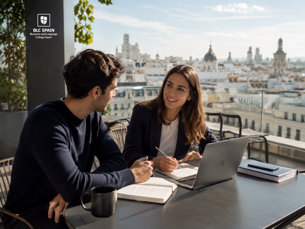 Student reviewing notes in a modern Madrid workspace with the city skyline in the background.