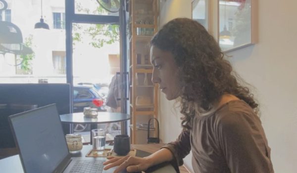 Master’s student studying on laptop at a café in Madrid